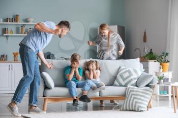 Angry parents scolding their little children at home�