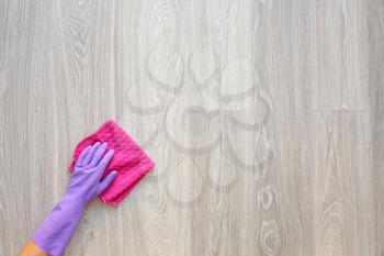 Woman cleaning wooden floor, top view�