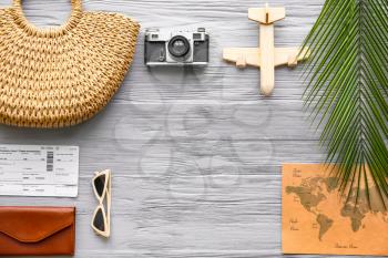 Composition with female accessories, tickets, photo camera and map on wooden background�