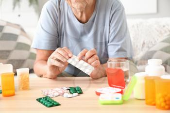 Elderly woman with medicines at home�