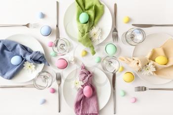 Table setting for Easter celebration on white background�