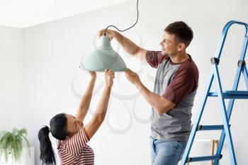 Happy couple doing repair in their new house�