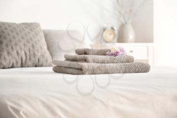 Stack of clean towels on bed�