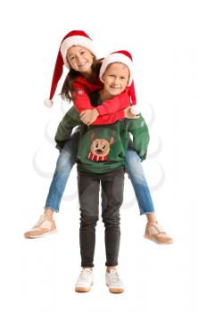 Little children in Christmas sweaters and Santa hats on white background�