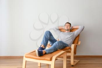 Man with headphones relaxing at home�