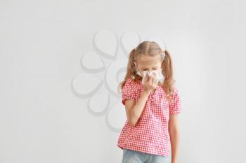 Little girl suffering from allergy on light background�