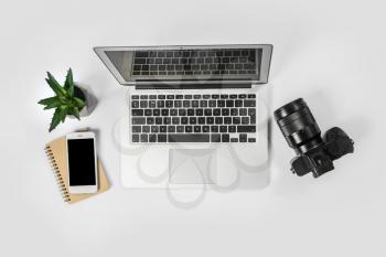 Comfortable workplace of photographer with laptop on white background�