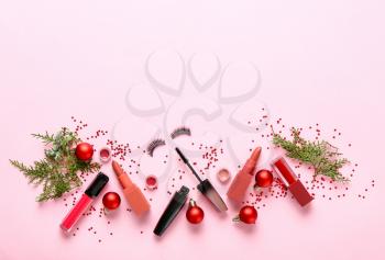 Set of cosmetics with Christmas decor on color background�