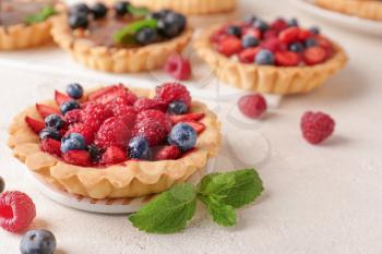 Sweet tartlet with berries on light table�