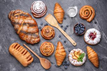 Assortment of sweet pastry on grey background�