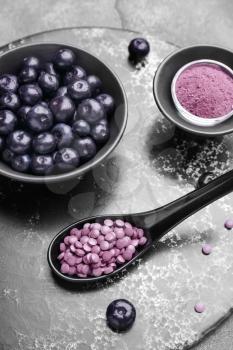 Acai berries with powder and tablets on board�