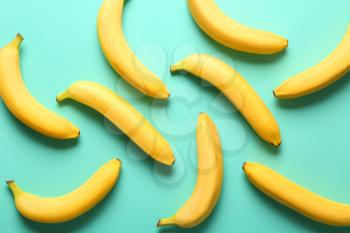 Many sweet ripe bananas on color background�