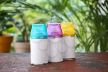 Air fresheners on table against blurred background�