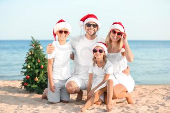 Happy family celebrating Christmas at tropical resort�