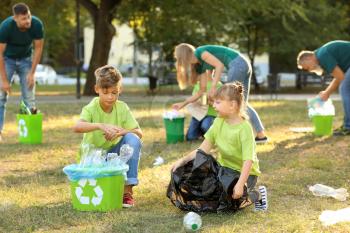 People gathering garbage outdoors. Concept of recycling�