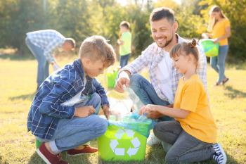 People gathering garbage outdoors. Concept of recycling�