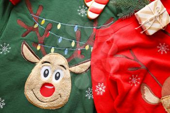 Funny Christmas sweaters on table�