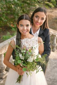 Beautiful lesbian couple on their wedding day outdoors�