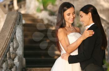 Beautiful lesbian couple on their wedding day outdoors�