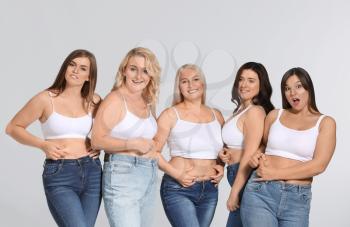Group of body positive women on grey background�