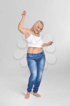 Mature body positive woman on grey background�