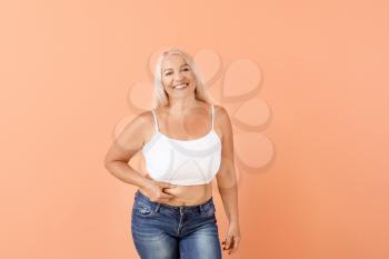 Portrait of mature body positive woman on color background�