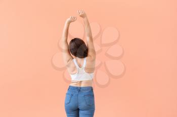 Young body positive woman on color background�