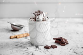 Cup of hot chocolate with marshmallows on white table�