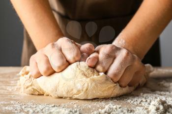 Woman kneading flour in kitchen, closeup�