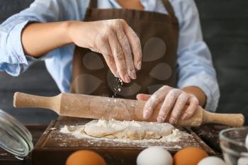 Woman making dough in kitchen�