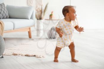 Cute little baby learning to walk at home�