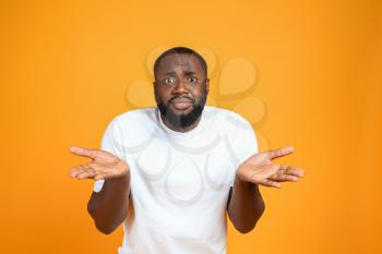Helpless African-American man on color background�