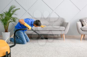 Young man cleaning his flat�