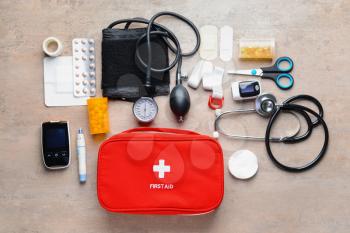 First aid kit on grey background�