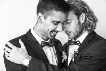 Black and white portrait of happy gay couple on their wedding day�