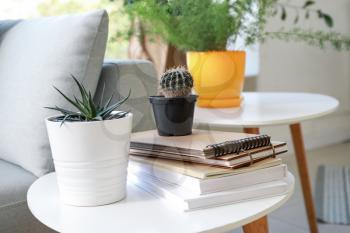 Houseplants with books on table in room�