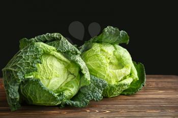 Fresh savoy cabbage on wooden table�