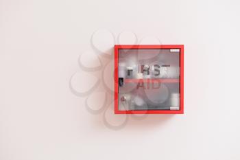 Wall mounted first aid kit on light background�