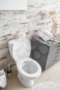 Clean toilet bowl in stylish interior of restroom�