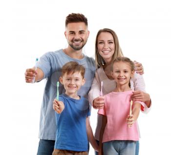Portrait of family with toothbrushes on white background�