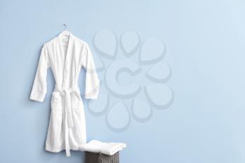 Clean bathrobe hanging on wall in room�