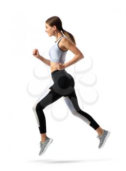 Sporty young woman running against white background�