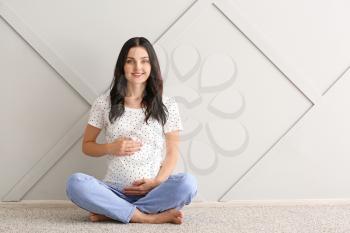 Beautiful young pregnant woman at home�