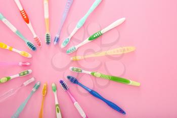 Many different tooth brushes on color background�