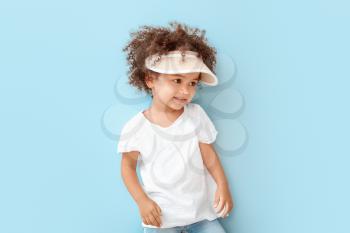Portrait of little African-American girl on color background�