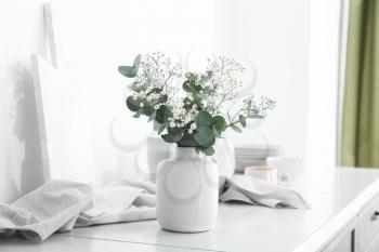 Vase with beautiful bouquet on table in kitchen�