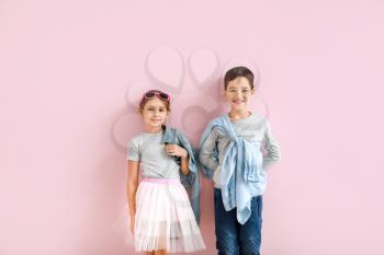 Cute fashionable children on color background�