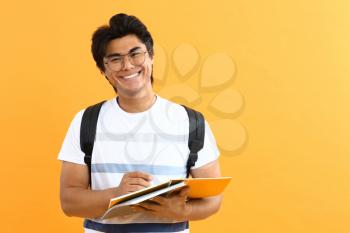Portrait of handsome Asian student on color background�