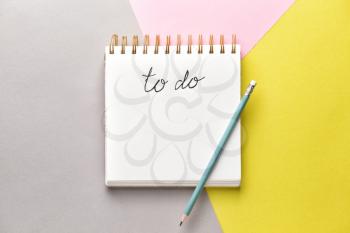 Empty to do list and pencil on color background�