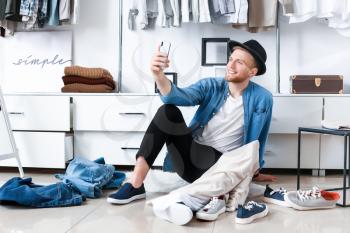 Stylish young man taking selfie in dressing room�